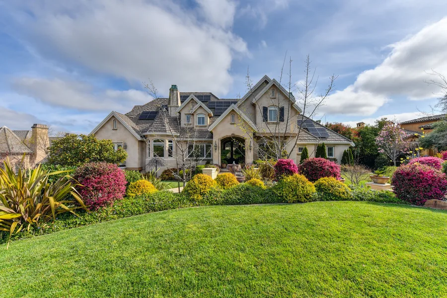 A well-kept suburban garden with lawn and planted borders